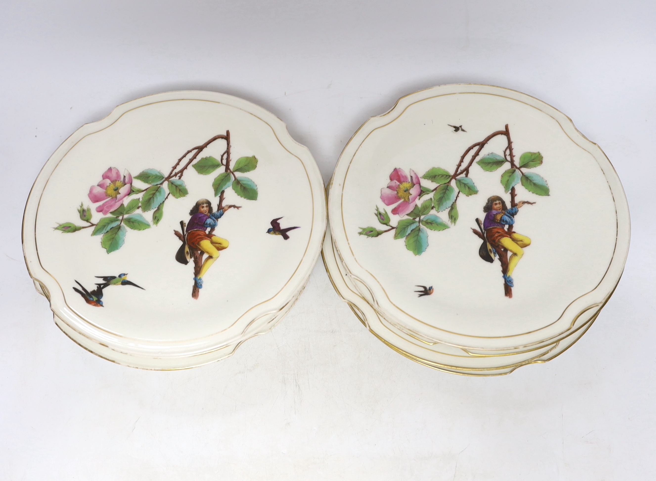 A set of eight late 19th century French Porcelain dessert plates decorated with scenes of figures on branched swings surrounded by flowers, 24cm diameter